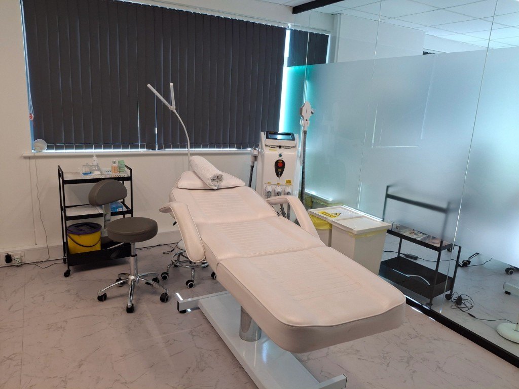Treatment couch, lamp and clinical trolley in a hired aesthetic treatment room